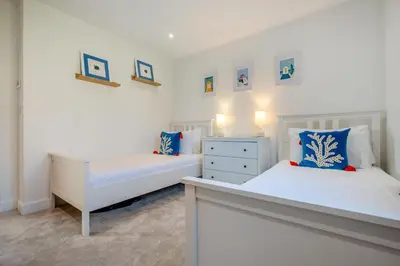 a bedroom with two beds and a dresser at 4 Bed in Porthleven oc-ch30536 in Porthleven