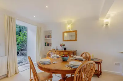 a dining room with a wooden table and chairs at 2 Bed in Polruan oc-g30534 in Fowey