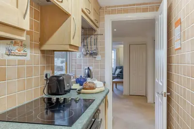 a kitchen with a stove and a counter top at 2 Bed in Polruan oc-g30534 in Fowey