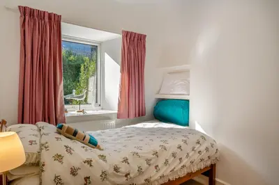 a bedroom with a bed and a window at 3 Bed in Polruan oc-g30535 in Fowey