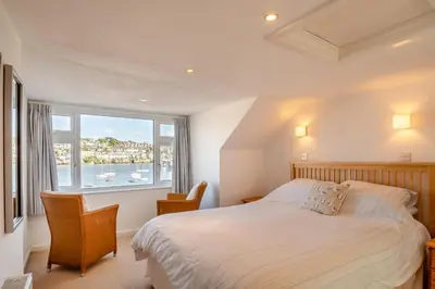 a bedroom with a bed and a large window at 3 Bed in Polruan oc-g30535 in Fowey