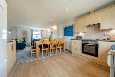 a kitchen and dining room with a table and chairs at 4 Bed in Newquay oc-c30589 in Saint Columb Major