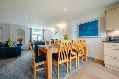 a kitchen and dining room with a table and chairs at 4 Bed in Newquay oc-c30589 in Saint Columb Major