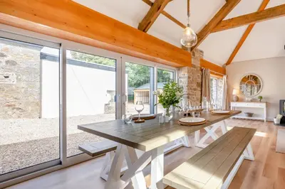 a dining room with a table and large windows at 2 Bed in St. Gluvias oc-c29724 in Ponsanooth