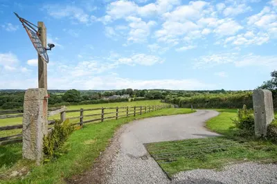 a country road with a fence and a sign at 2 Bed in St. Gluvias oc-c29724 in Ponsanooth