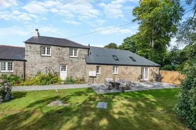 a large stone house with a yard with a yard at 2 Bed in St. Gluvias oc-c29724 in Ponsanooth