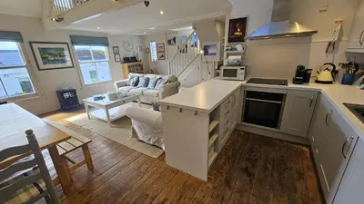 a kitchen and living room with a couch and a table at Workshop in Saint Mawes