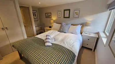 a bedroom with a bed with a pair of shoes on it at Workshop in Saint Mawes