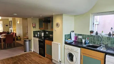 a kitchen with a washer and dryer in a room at Charlies in Saint Mawes