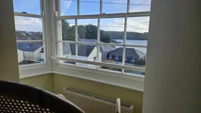 a window with a view of a house at Charlies in Saint Mawes