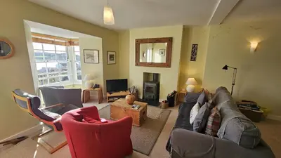 a living room with a couch and chairs at Charlies in Saint Mawes