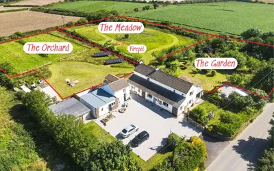 an aerial view of a white house with the kitchen and the garden at The Sty, rural retreat for couples in Falmouth