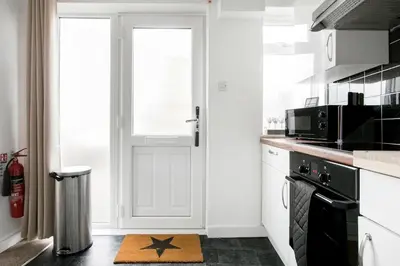 a kitchen with a star rug on the floor at Life of Riley in St Ives