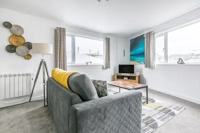 a living room with a couch and a table at Life of Riley in St Ives