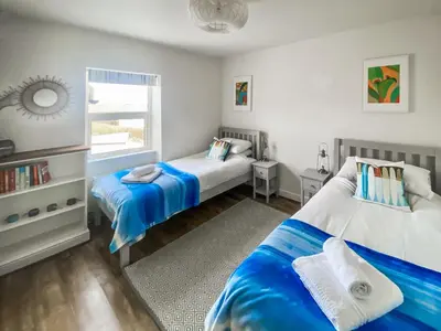 a bedroom with two beds and a window at Greycott - Uk48746 in Crantock