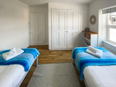 a bedroom with two beds and a window at Greycott - Uk48746 in Crantock