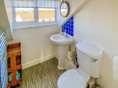 a small bathroom with a toilet and a sink at Greycott - Uk48746 in Crantock