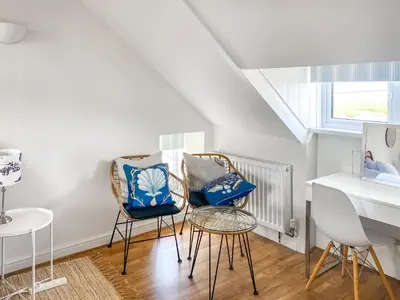 a living room with two chairs and a table at Greycott - Uk48746 in Crantock