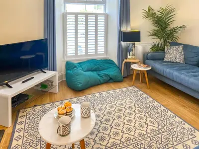 a living room with a blue couch and a table at Greycott - Uk48746 in Crantock