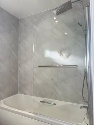 a shower in a bathroom with a white tub at Sea Spire Coach House in Charlestown