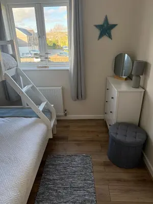 a bedroom with a bed and a star on the wall at Sea Spire Coach House in Charlestown