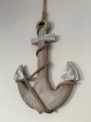 a wooden sign with a cross on a wall at Sea Spire Coach House in Charlestown