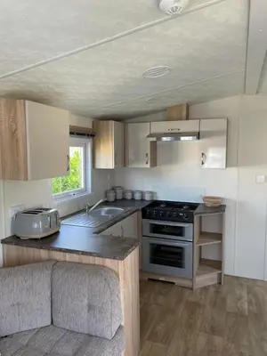 a kitchen with a stove and a sink at Mounts Bay Caravan Park in Penzance