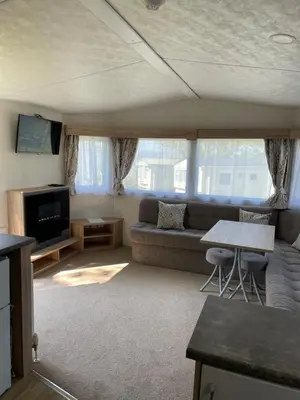 a living room with a couch and a table at Mounts Bay Caravan Park in Penzance