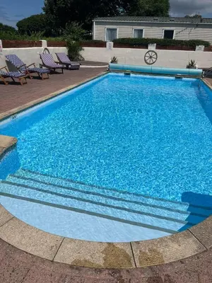 a large blue swimming pool with blue water at Mounts Bay Caravan Park in Penzance
