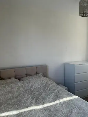 a bedroom with a bed and a dresser at Peaceful room near to beach - Newquay Porth in Saint Columb Minor