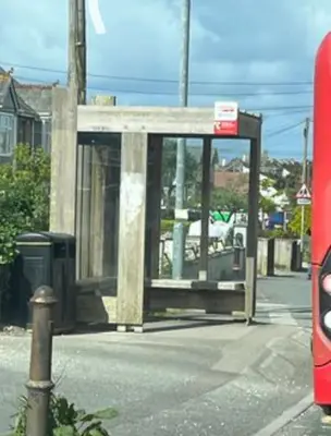 a bus stop on the side of a street at Peaceful room near to beach - Newquay Porth in Saint Columb Minor