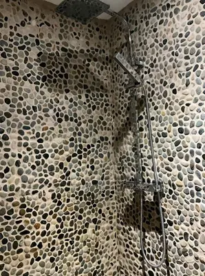 a bathroom with a shower with a mosaic wall at Peaceful room near to beach - Newquay Porth in Saint Columb Minor