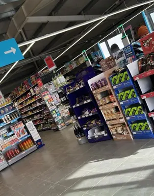 a store aisle of a grocery store with many products at Peaceful room near to beach - Newquay Porth in Saint Columb Minor