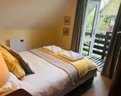 a bedroom with a bed and a large window at Trevithick 46 in Hayle