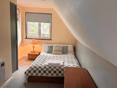 a small bedroom with a bed and a window at Trevithick 46 in Hayle