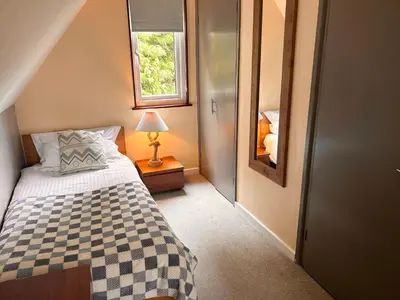 a small bedroom with a bed and a window at Trevithick 46 in Hayle