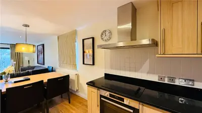 a kitchen with a table and a counter top at Hustyn Lodges in Saint Wenn