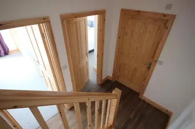 a view of a bedroom with a staircase and a door at TwoPigalliie Heights in Nancekuke