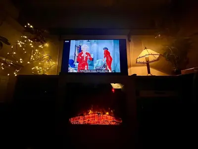 a living room with a fireplace with a tv and a fire at Newquay Seaside Lodge Retreat with Hot Tub in Newquay