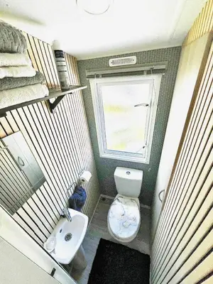 a small bathroom with a toilet and a sink at Newquay Seaside Lodge Retreat with Hot Tub in Newquay