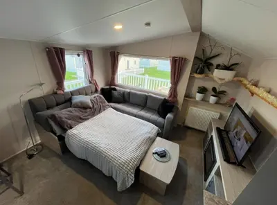 a small room with a bed and a couch at Newquay Seaside Lodge Retreat with Hot Tub in Newquay