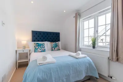 a bedroom with a bed with towels on it at The White House in Wadebridge