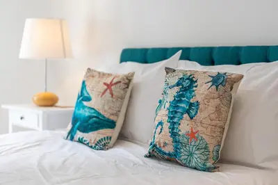 a bed with two pillows on top of it at The White House in Wadebridge