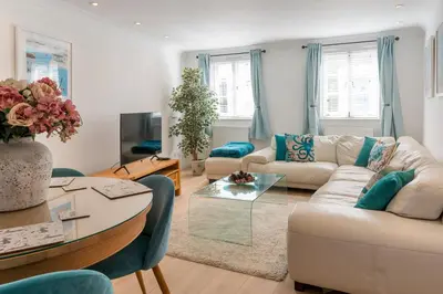 a living room with a couch and a table at The White House in Wadebridge