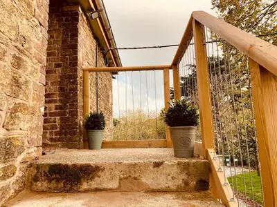 two potted plants sitting on the stairs of a building at Bream Loft, dog friendly, wood burner, walking distance to beach in Falmouth