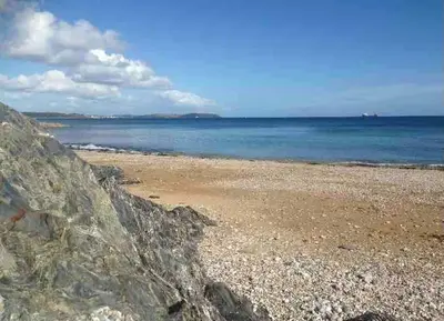 a beach with the ocean in the background at Bream Loft, dog friendly, wood burner, walking distance to beach in Falmouth