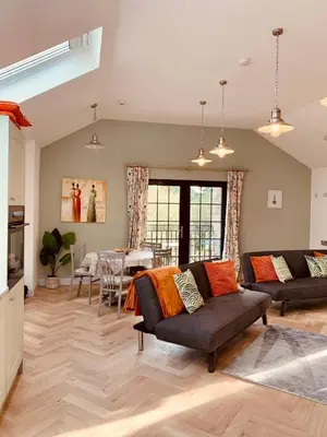 a living room with a couch and a table at Bream Loft, dog friendly, wood burner, walking distance to beach in Falmouth