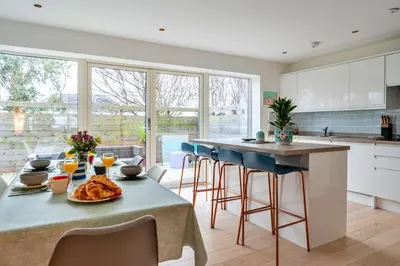 a kitchen with a table with food on it at Finest Retreats - Tamsin in Newquay