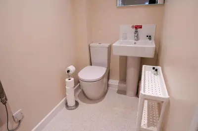 a small bathroom with a toilet and a sink at Epiphany House in Kenwyn