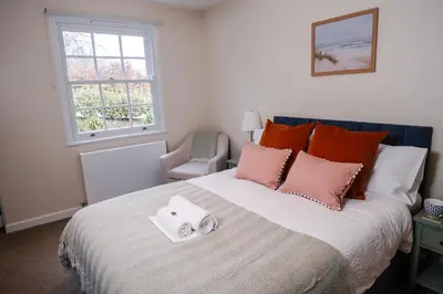 a bedroom with a bed with two towels on it at Epiphany House in Kenwyn